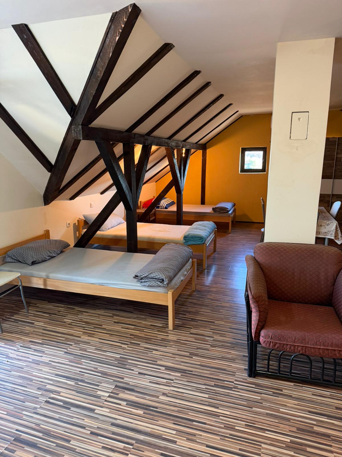 Soba sa dva kreveta i sivim zidovima